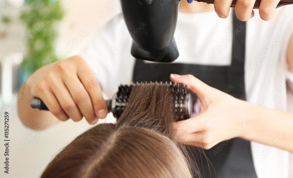 Professional hairdresser drying hair