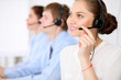 © rogerphoto - Call center operators. Young beautiful business woman in headset.