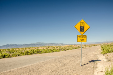 Pavement Ends and becomes dirt as indicated on the sign and as seen in the photo