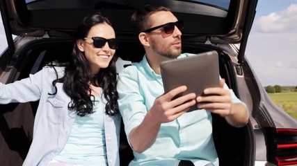 Poster - happy couple with tablet pc at hatchback car trunk 5