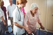 © WavebreakMediaMicro - Nurse helping a retired woman to walk