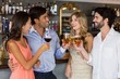 © WavebreakmediaMicro - Group of friends toasting red wine and champagne