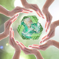 Wall Mural - Collaborative human hands protecting green planet with recycle arrow sign leaf on blur abstract background: Recycle reduce reuse eco business CSR concept: Element of image furnished by NASA