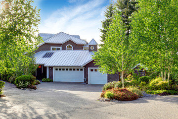 Modern house exterior with curb appeal. View of garage and spacious driveway