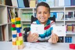 © WavebreakMediaMicro - Disabled boy showing placard that reads I Can in library