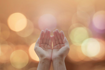 empty female open human hands with palms up on blurred abstract background candle lights night bokeh
