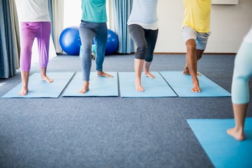 Instructor performing yoga with seniors