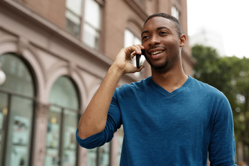 Canvas Print - Young man in city talking on cell phone