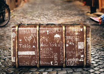 Wall Mural - retri suitcase of a traveler with travel marks
