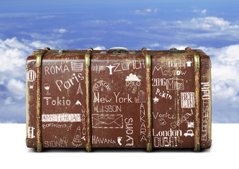 Wall Mural - full suitcase of a traveler with travel marks