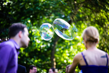 Sticker - young couple having fun with soap bubbles