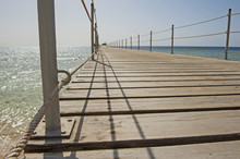 Wooden Pier From Beach On Tropical Sea