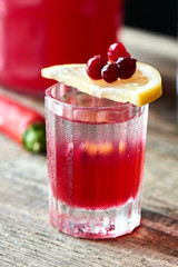 Wall Mural - Boyarsky alcoholic cocktail consisting of vodka, homemade cranberry and Tabasco in a glass on wooden table closeup