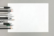 Various Drawing Tools And Blank Sheet Of Paper On Gray Office De