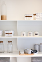 Natural Kitchenware In The Shelf Including Glass Bottles And Mug
