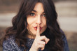 © kegfire - Portrait of beautiful woman with finger on lips.
