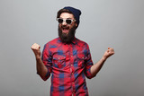 Fototapeta  - happy hipster man with beard exults