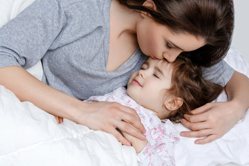 beautiful mother and daughter in bed