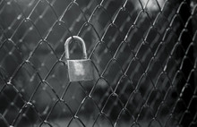 Portrait Of Key Lock Hook On Iron Wire Gates And Water Drop Of Rain With Blur Background,selective Focus,filtered Image,light Effect Added,black And White Picture Style