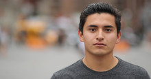 Young Latino Man In City Face Portrait Serious
