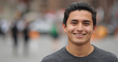 young latino man in city face portrait smile