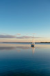 © wstockstudio - Sailing boat on a calm lake with reflection