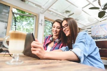 Two young friends taking selfie