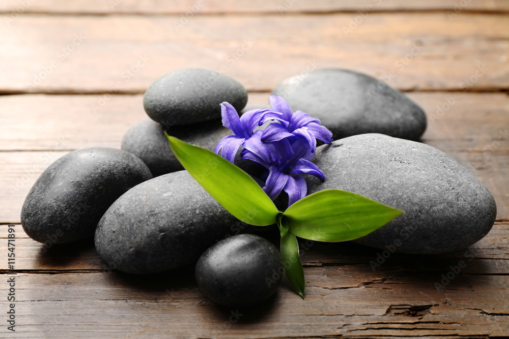 Heap of spa hot stones  on wooden table