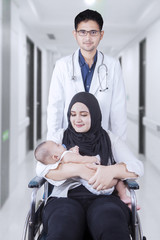 Poster - Male doctor with patient and her baby