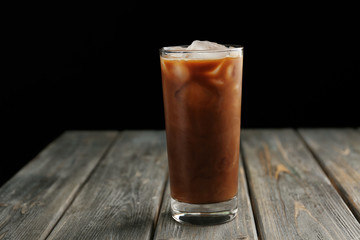 Wall Mural - Glass of iced coffee on wooden table