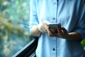 Wall Mural - Woman holding smartphone with touch on screen