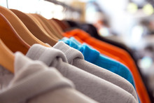 Row Of Spring Seasonal Apparel On Hangers Of Retail Shop