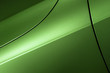 Surface of green sport sedan car, detail of metal hood, fender and door of vehicle bodywork 