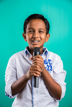 Young Indian Boy In White Shirt Yelling In Microphone, Little Kid Singing, Little Indian Boy With Microphone Sings A Song, Singing Asian Young Boy, Cute Young Asian Boy Singing Into A Microphone