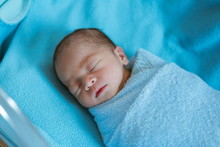 Newborn Baby Asia  While Sleeping Covered With Blue Cloth