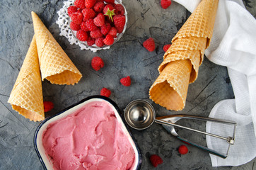 Poster - Raspberry ice cream with ice cream cones on stone table. Top view.