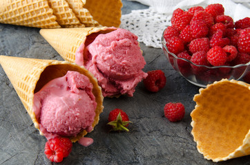 Poster - Raspberry ice cream with ice cream cones on stone table.