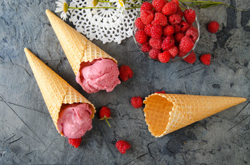 Poster - Raspberry ice cream with ice cream cones on stone table. Top view.