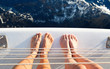 Couples feet on a yacht.

