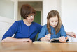 © FOLIO - Sweden, Portrait of grandmother helping granddaughter (6-7) with homework