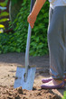 Gardener digging soil with shovel