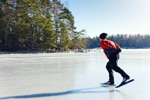 Man Ice Skating On Frozen Lake