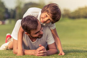 Wall Mural - Dad and son resting outdoors