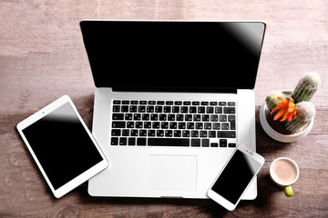 Canvas Print - Modern laptop, smart phone and tablet with coffee cup on a wooden table