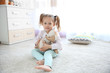 © Africa Studio - Small cute girl with teddy bear at home