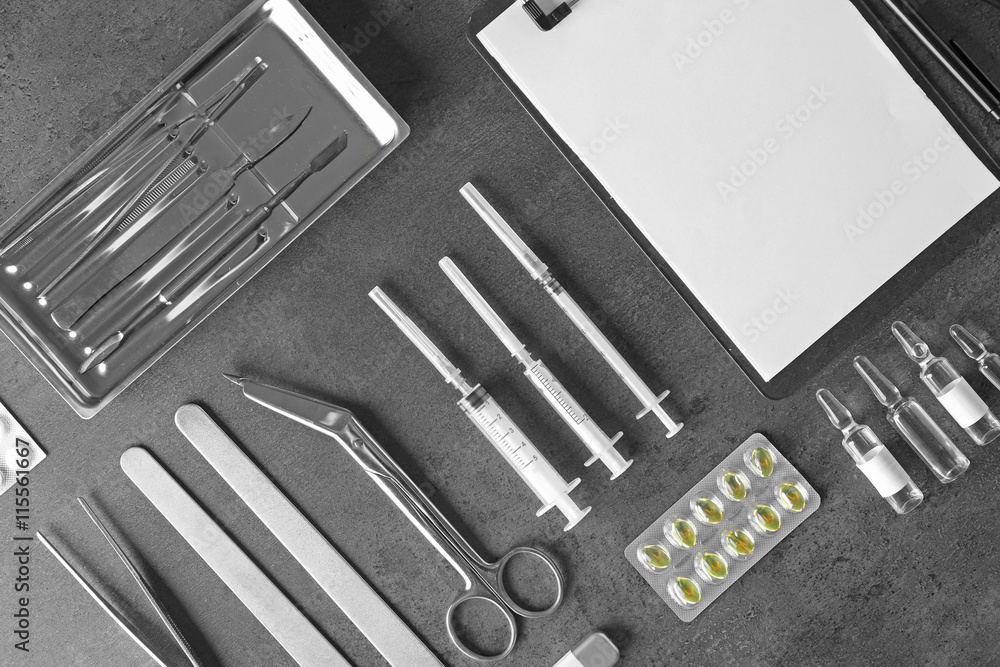 Medical tools set on dark gray background