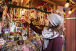 © FOLIO - Woman buying candy at market stall
