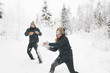 © FOLIO - Finland, Jyvaskyla, Saakoski, Young couple having snowball fight