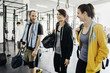 © FOLIO - Young women and man talking with each other in gym