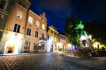 Cobblestone street and medieval architecture at night, in the Ol